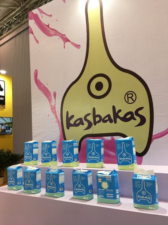 Kasbakas logo wall with pet pads packs on display at a trade show